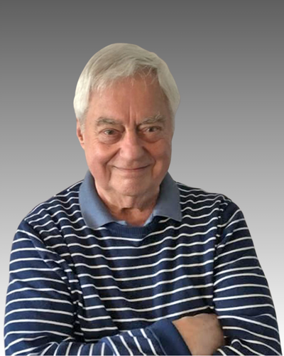 Profile of Vaughn Wadelius smiling with arms crossed